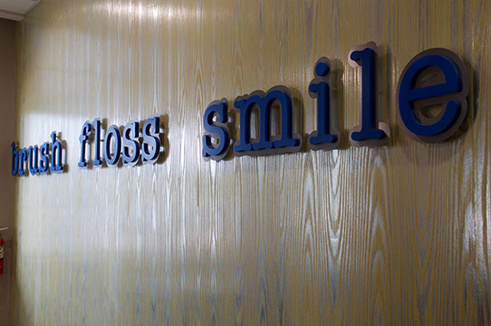 photo of words on our wall "brush floss smile"